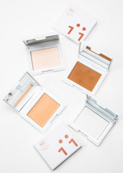 four open perfecting powder compact in four shades with mirrors and two closed 