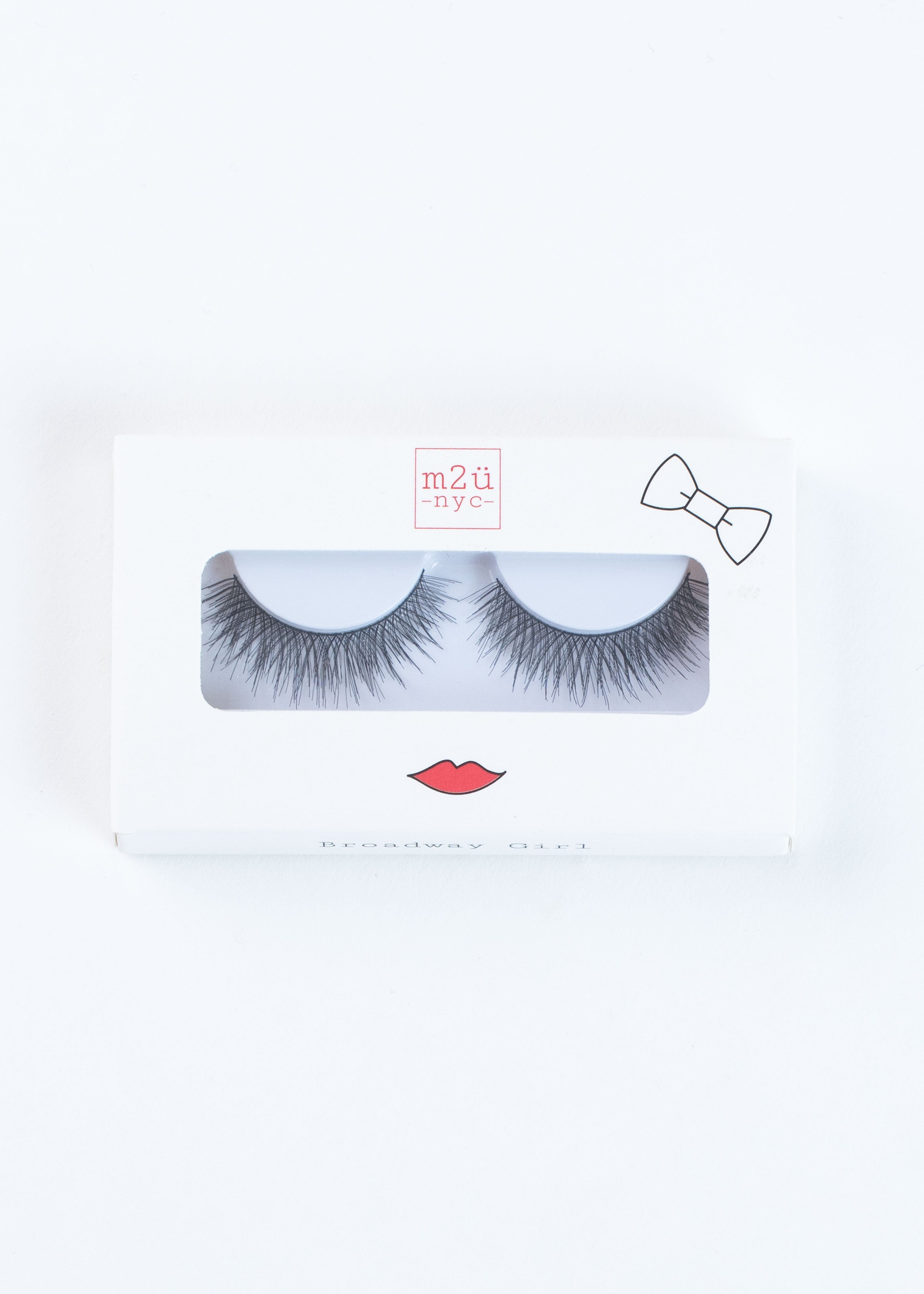a pair of dramatic volume style false eyelashes in a white box with red lips