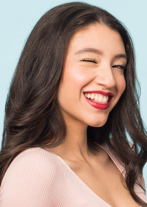 winky smiling girl wearing moisturizing lipstick in shade uptown