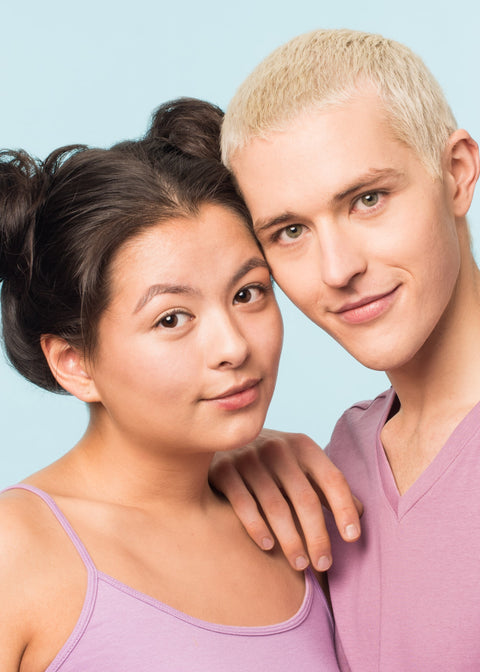 girl and man wearing perfecting powder smiling and leaning onto each other's heads