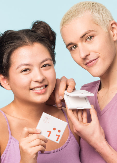 girl and man both smiling each holding one compact perfecting powder 