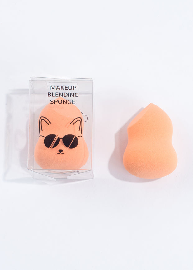 two dual-ended orange makeup blending sponges, one in the clear box with fox illustration on and one with no box 